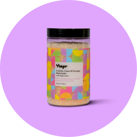 Unboxed SHOPE bath salts against purple circle background.