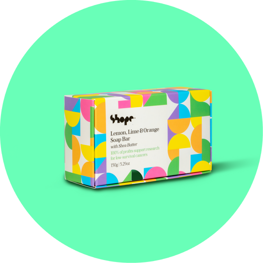 Boxed SHOPE soap bar against green circle background.